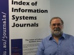 John Lamp, standing in front of a banner saying "Index of Information Systems Journals