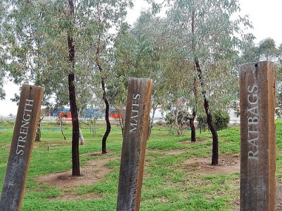 A country scene, with three posts in the foreground: Strength; Mates; Ratbags.