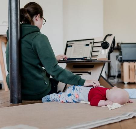 mother working from home and taking care of her baby
